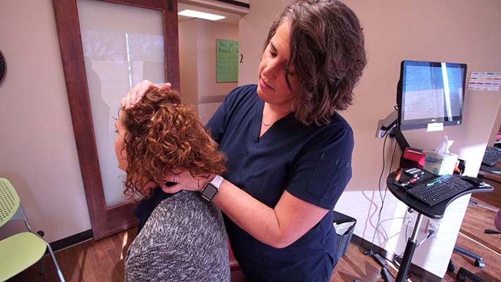 Chiropractor Omaha NE Sheri Millard Adjusting Patient